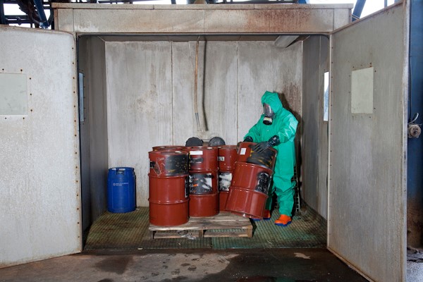 Water reactive compound drums ready for treatment in a specially designed black box